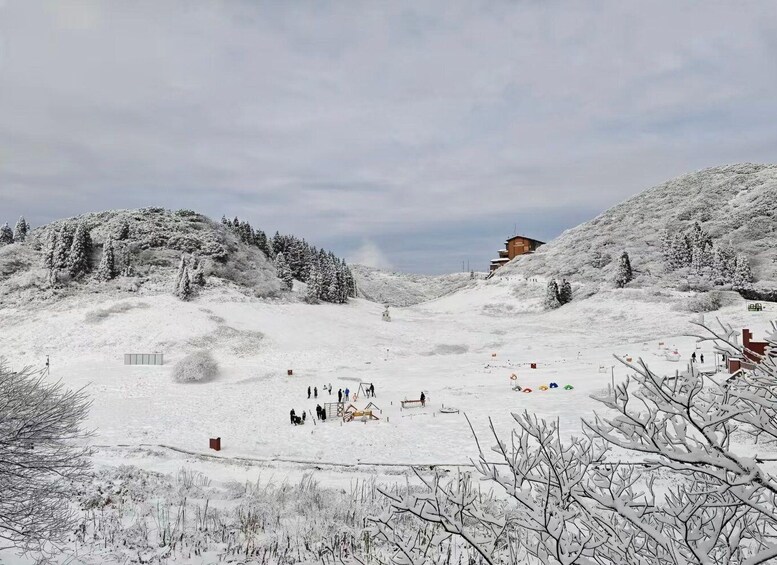 A snowy mountain landscape with a ski resort, including ski lifts and a lodge. 5