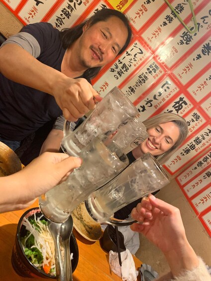 A group of people toasting with glasses filled with ice cubes. 4