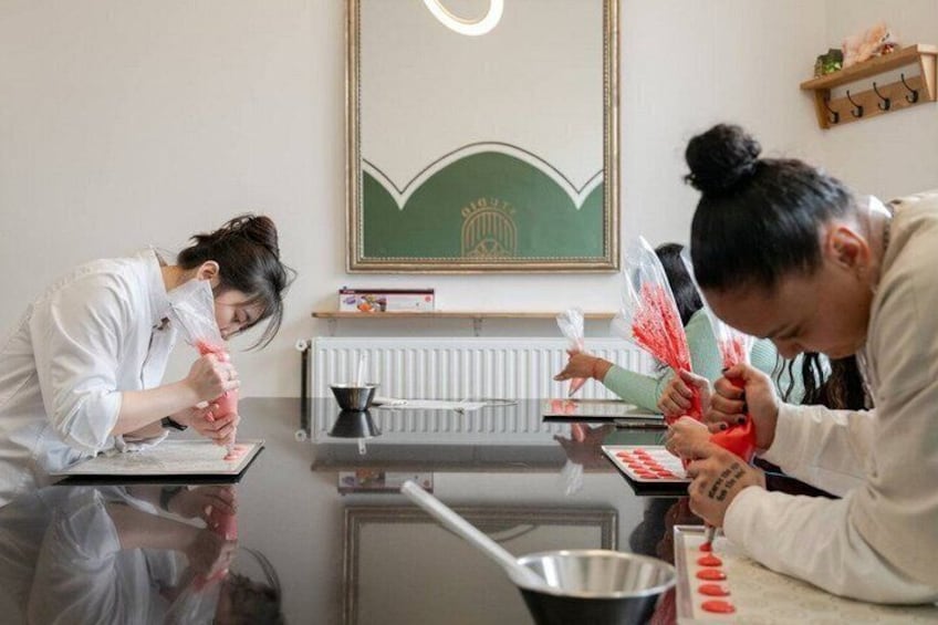 Two individuals engaged in a food preparation activity, with kitchen utensils and ingredients visible. 5