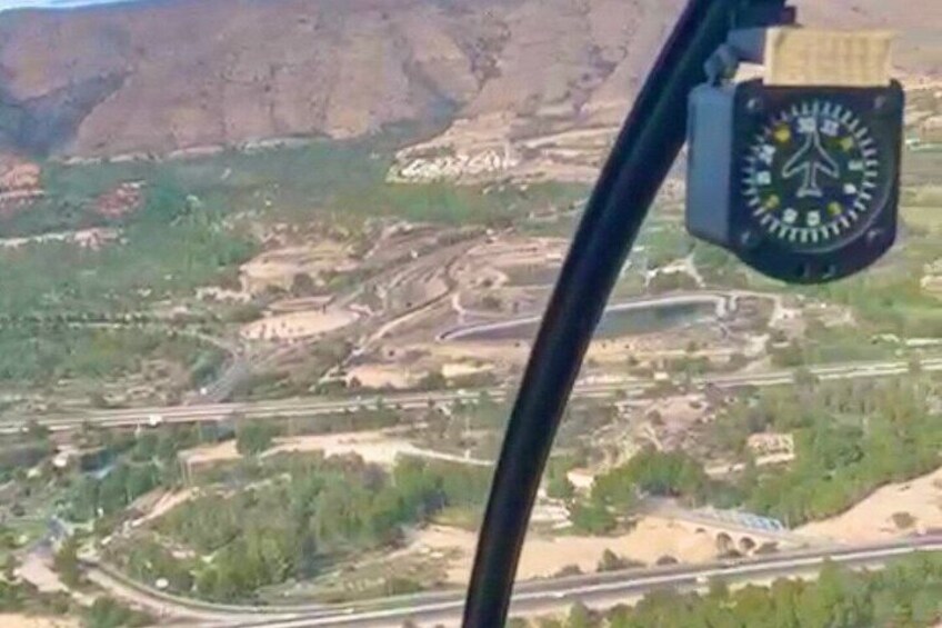 A mountainous landscape with a road winding through it. 2
