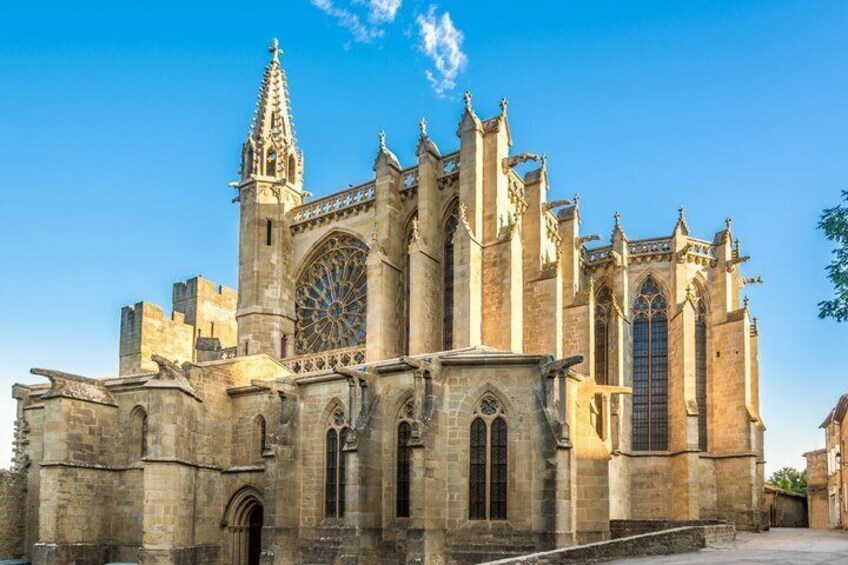 A Gothic cathedral with a large rose window, pointed arches, and a spire. 2
