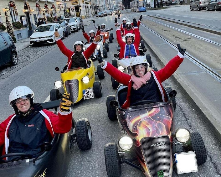 People in go-karts on a city street. 1