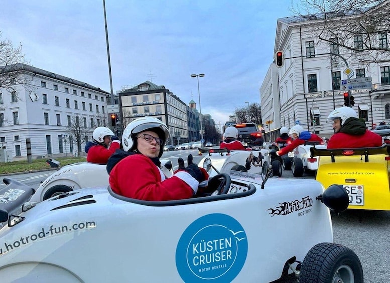 People in go-karts on a city street. 3