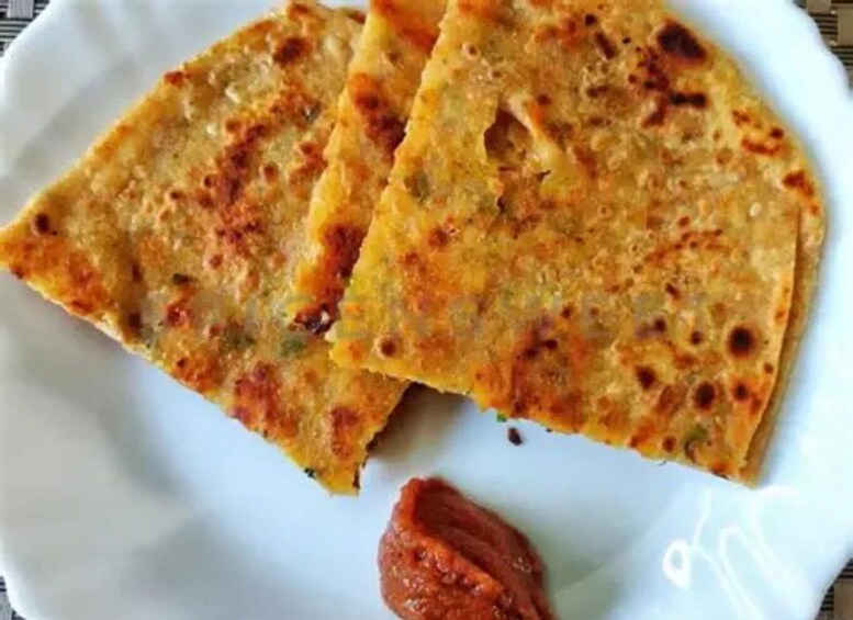 Three pieces of flatbread on a white plate. 1