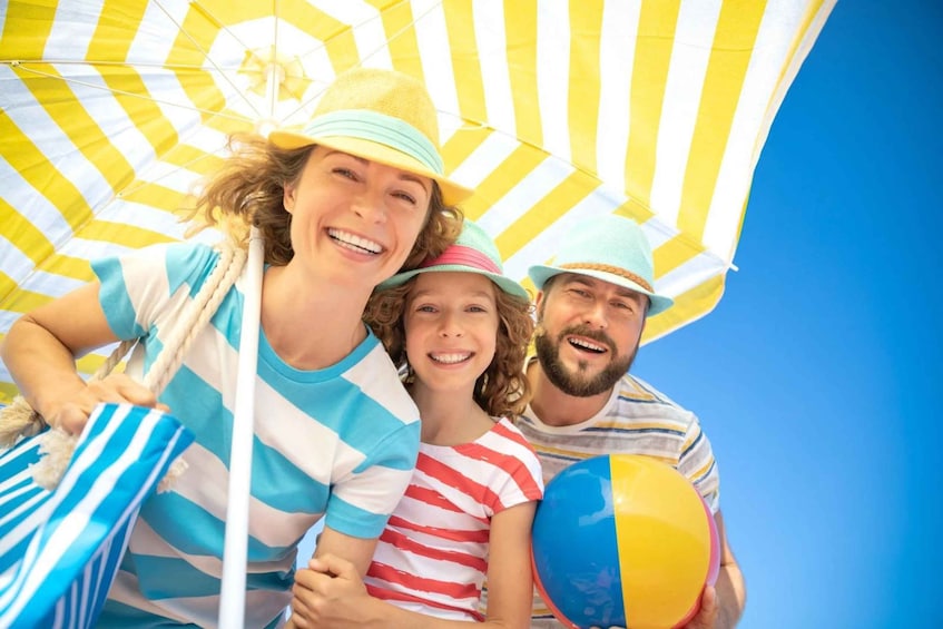 A family under a striped umbrella. 3