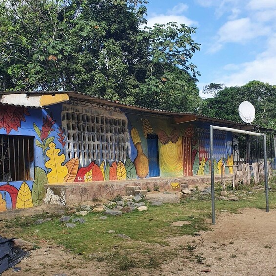 A colorful mural with leaf patterns and a satellite dish. 4