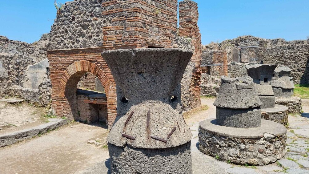 Ancient ruins with brick structures and stone columns. 1