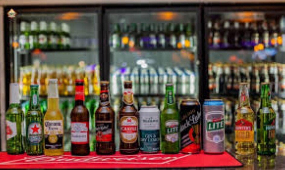 A variety of alcoholic beverages displayed on a bar counter. 2