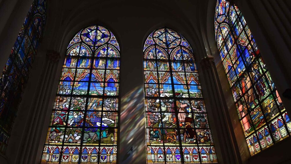 Two large stained glass windows with intricate designs and multiple colors. 2