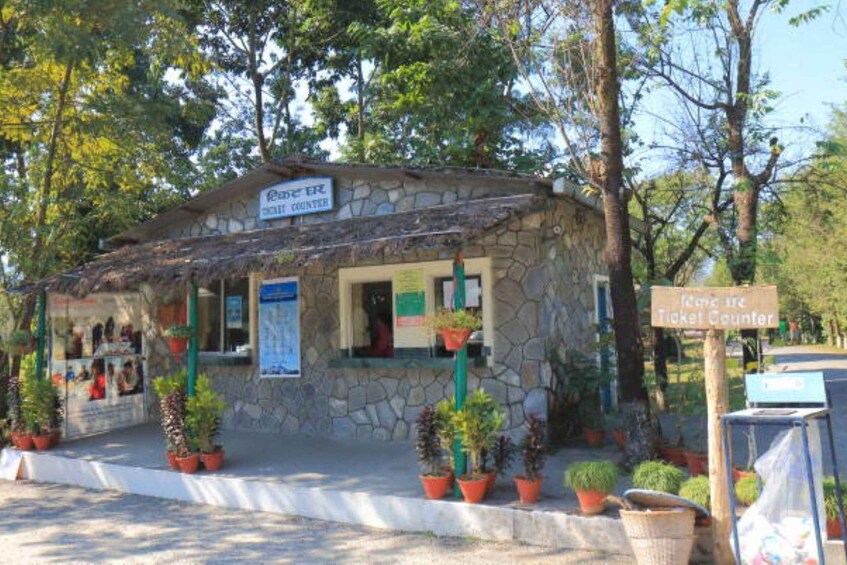 A stone building with a sign for the 'Rural Bank' and a 'Ticket Counter' sign. 5