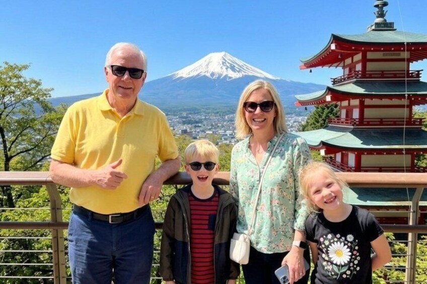 A family with a view of Mount Fuji and a pagoda. 2
