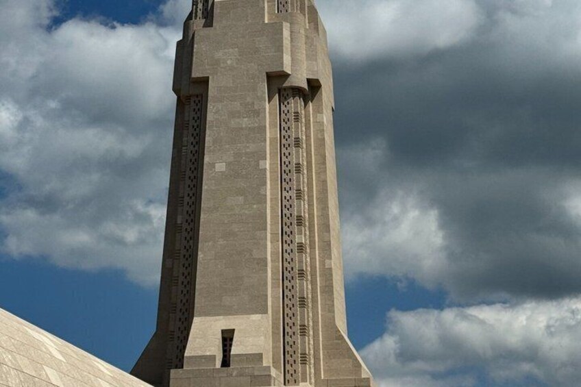 A tall, narrow tower with vertical lines and a flat roof. 5
