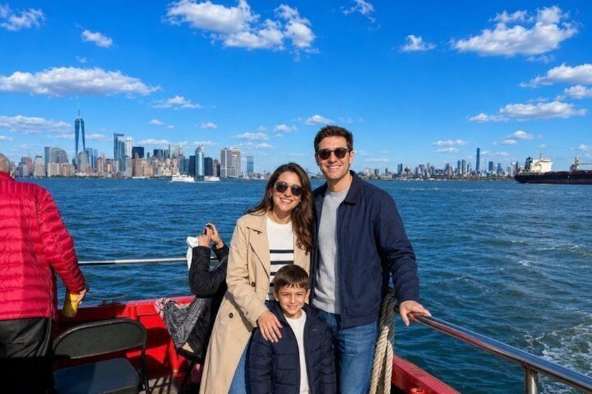 A family on a boat with a city skyline in the background. 2
