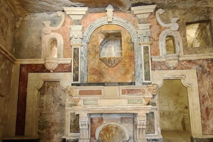 An ancient fresco with architectural elements, including a central arch and decorative moldings. 2