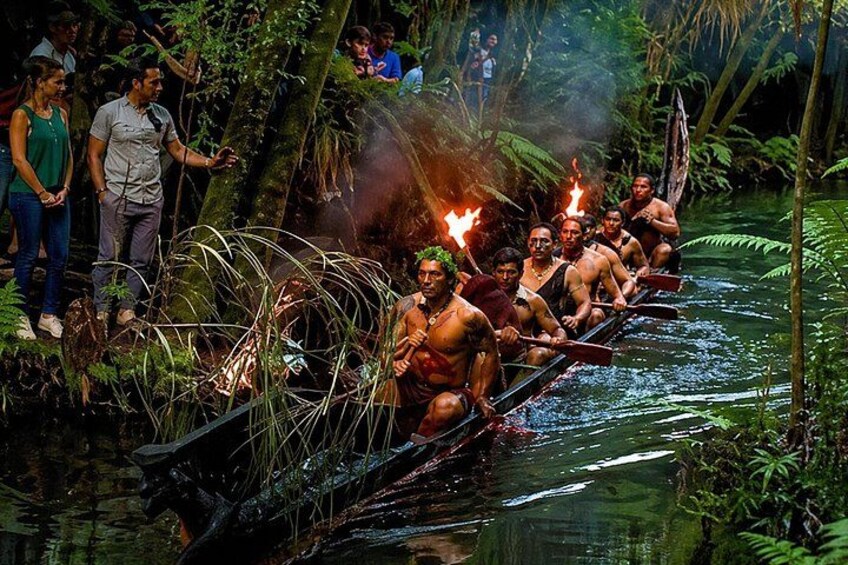 A group of people in a canoe on a river surrounded by dense vegetation. 2