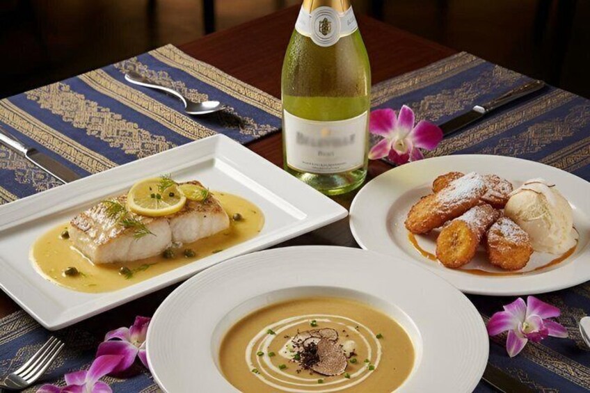 A table with three dishes: fish with sauce, a dessert with ice cream, and a soup with garnish. 1