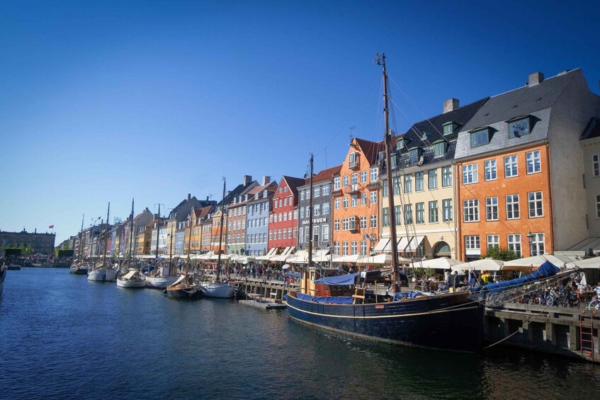 A waterfront with colorful buildings and boats docked along the pier. 4