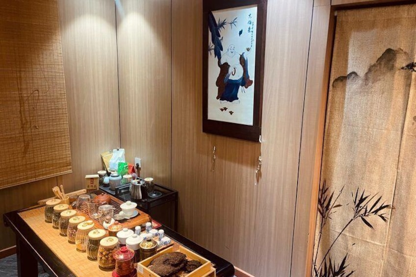 A traditional Japanese room with tatami flooring, a shoji screen, and a tea ceremony setup. 5