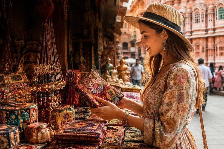 A person examining a colorful textile at a market stall. 3