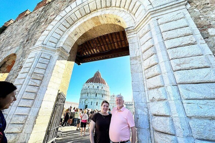 A stone archway with a dome in the background. 3