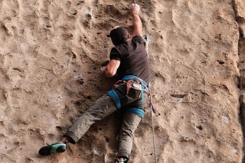A person climbing a rocky wall. 3