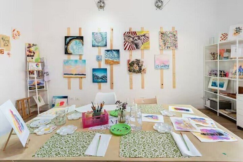 An art studio with easels, canvases, and art supplies. 4