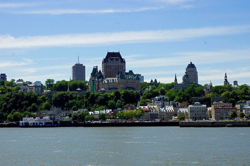 A city skyline with prominent buildings, a river, and a boat. 4