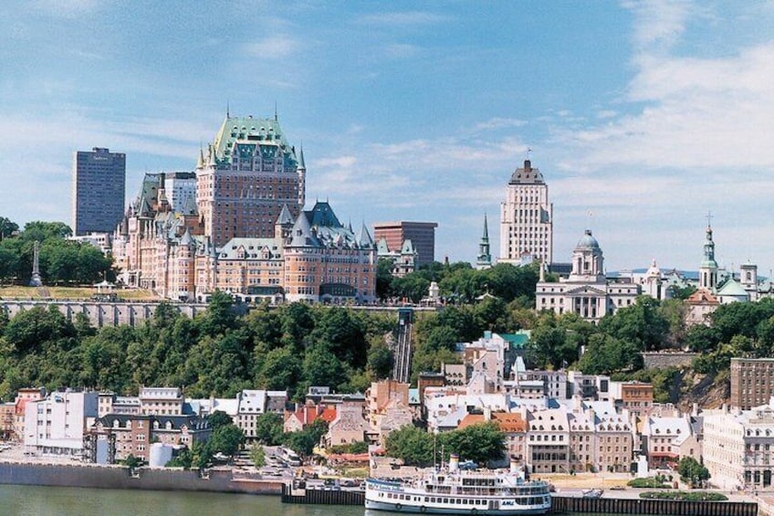 A cityscape with historic buildings, a prominent castle-like structure, and a river with a boat. 1