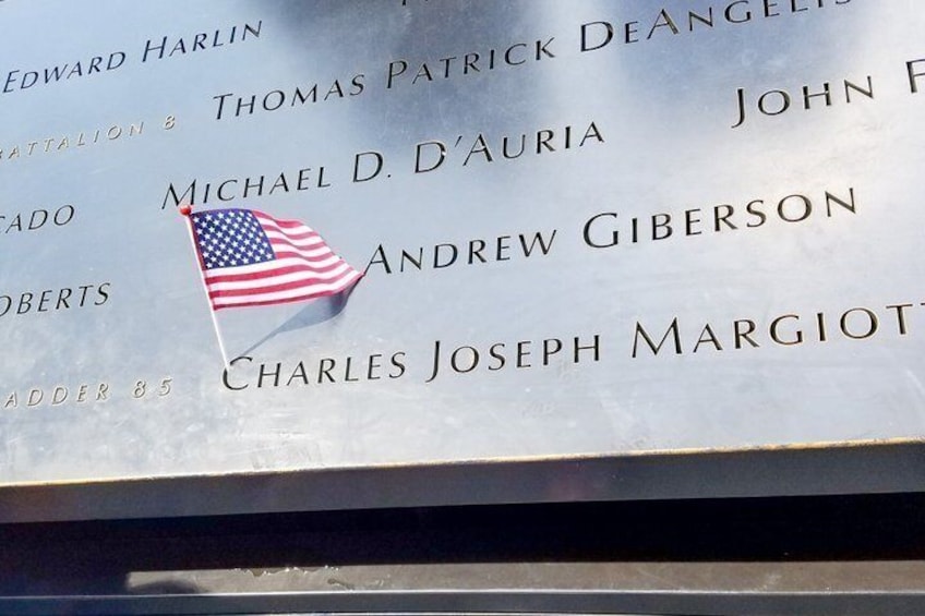 A memorial plaque with names and an American flag. 2