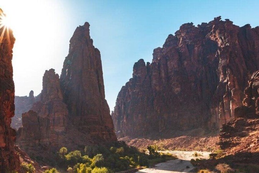 A canyon with tall rock formations and a river. 1