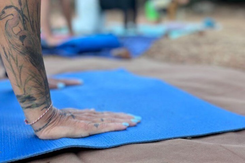 A person performing a yoga pose on a blue mat. 3