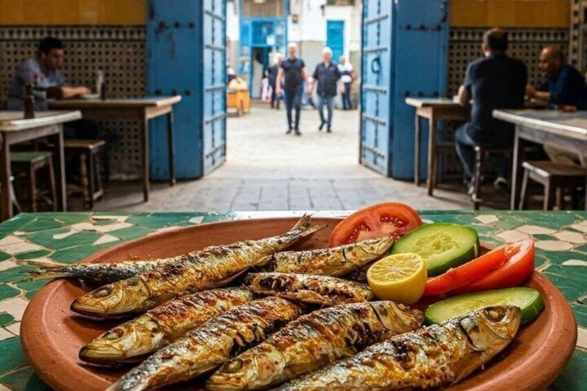 Grilled fish on a plate with sliced tomatoes and cucumbers. 2