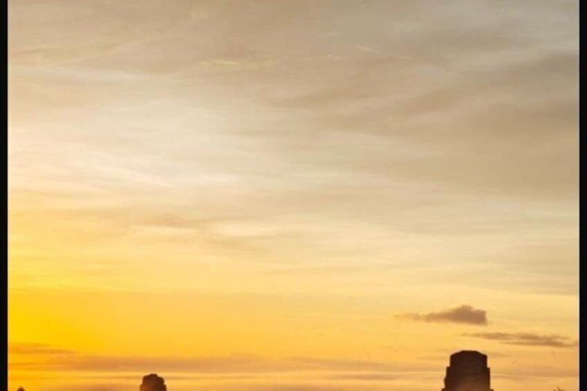 A sunset with a clear sky and silhouettes of rock formations. 2