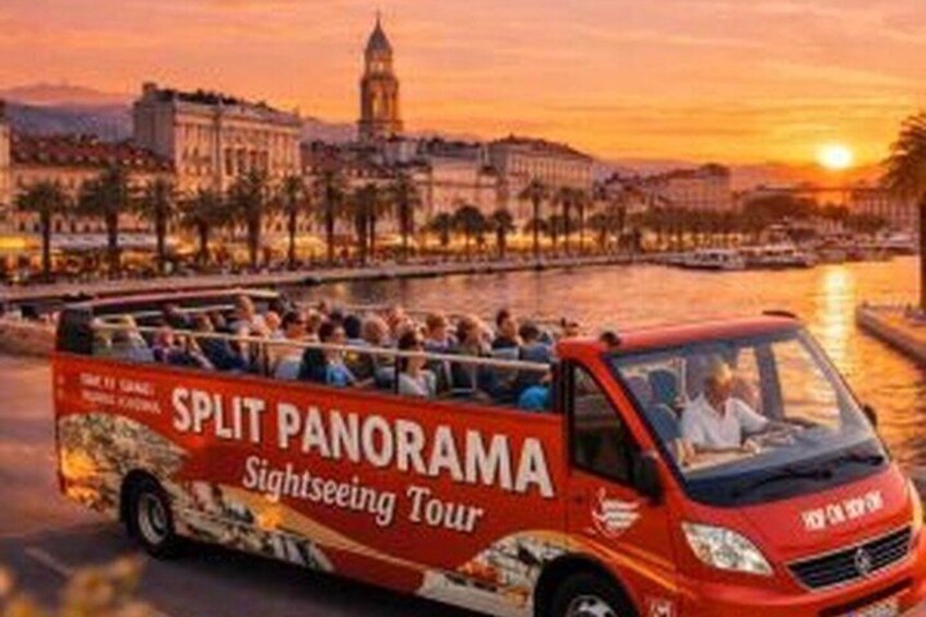 A red sightseeing tour bus with passengers, a river, and a cityscape with a prominent clock tower. 4