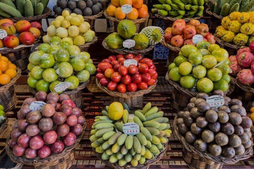 A variety of fruits and vegetables displayed in baskets at a market. 5