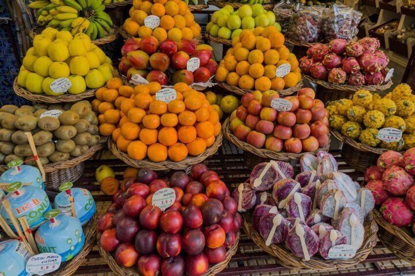 A variety of fruits and vegetables displayed in baskets at a market. 4
