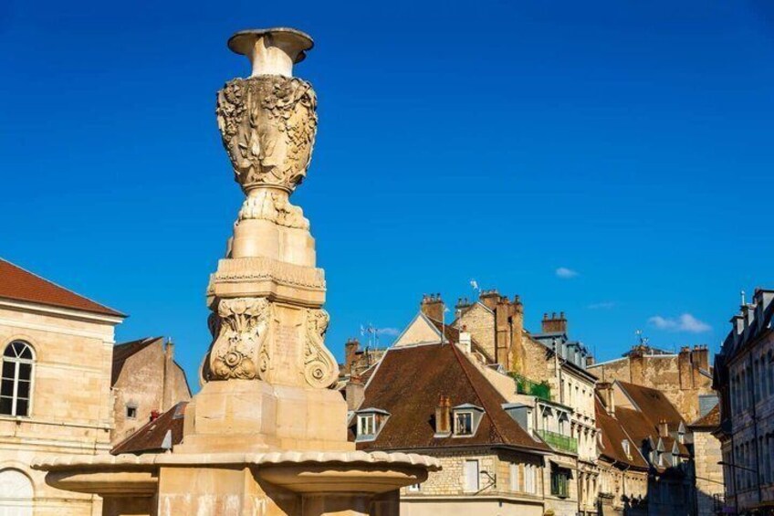 A historic fountain with intricate carvings, surrounded by traditional European architecture. 5