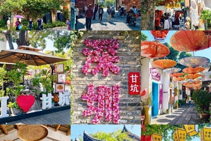 A bustling street with shops, a stone wall with pink flowers, and traditional umbrellas. 1
