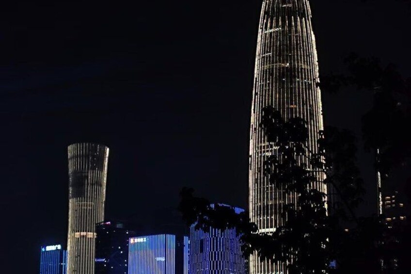 A city skyline at night with illuminated skyscrapers. 3