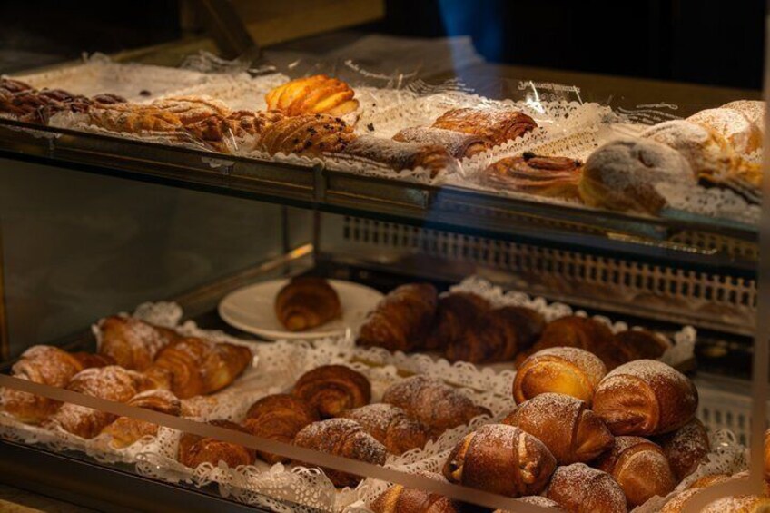 A bakery display case with various pastries and baked goods. 3