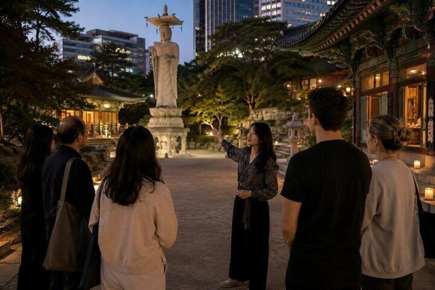 A group of people observing a traditional stone statue in a park with a pagoda in the background. 1