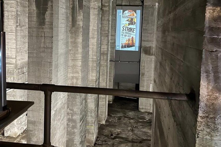 A concrete staircase with a poster advertising a strike. 3