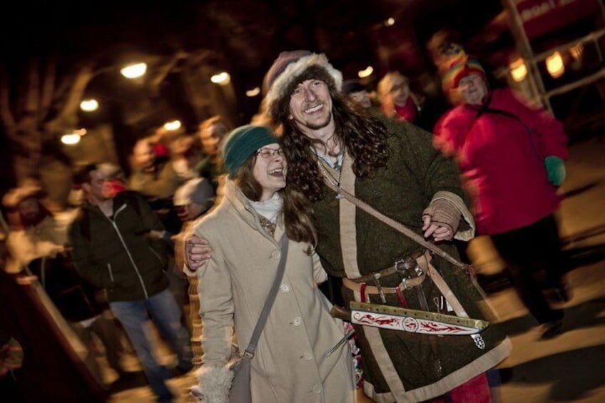 A person in a fur hat and coat, holding a wooden staff. 3