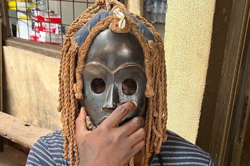 A person wearing a mask with braided hair and a rope headband. 5