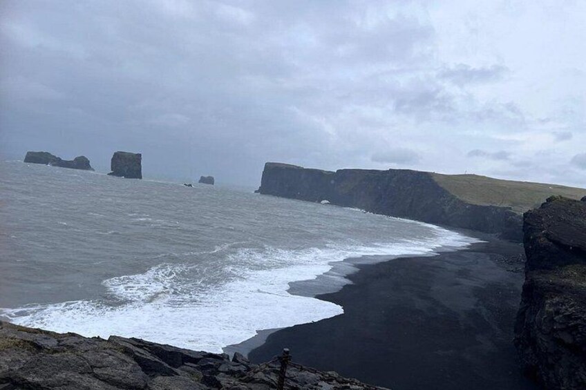 A coastal landscape with cliffs and a beach. 4