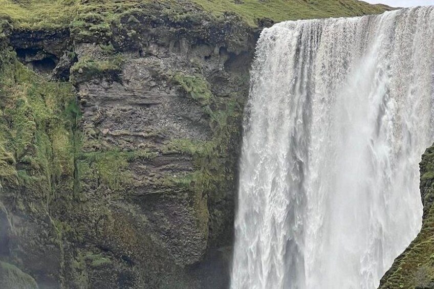 A large waterfall cascading down a rocky cliff. 2