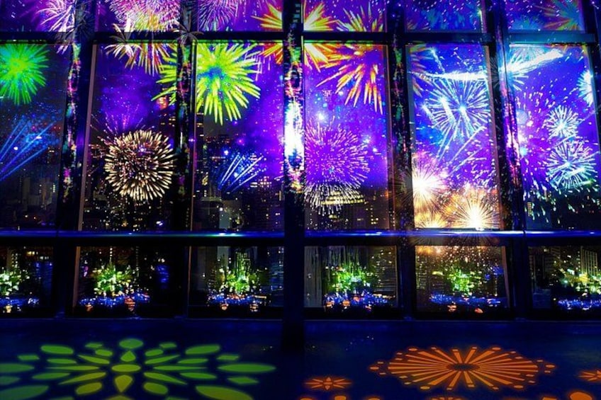 A building with multiple windows displaying colorful fireworks. 3