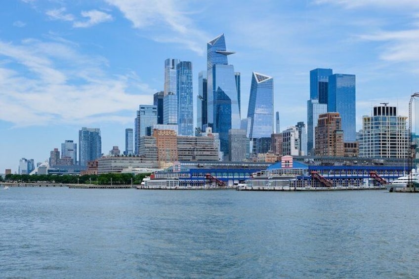 A city skyline with modern skyscrapers and a waterfront. 5