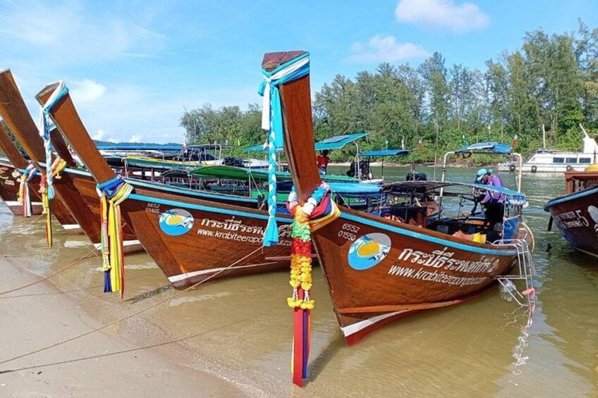Traditional wooden boats docked at a waterfront. 5