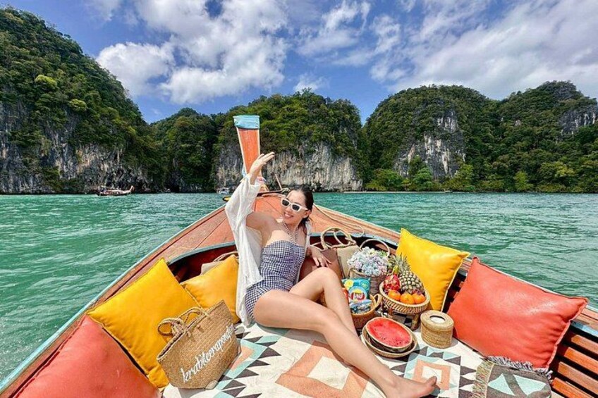 A person on a boat with a tropical landscape in the background. 4